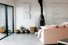 pink sofa and woodburner
